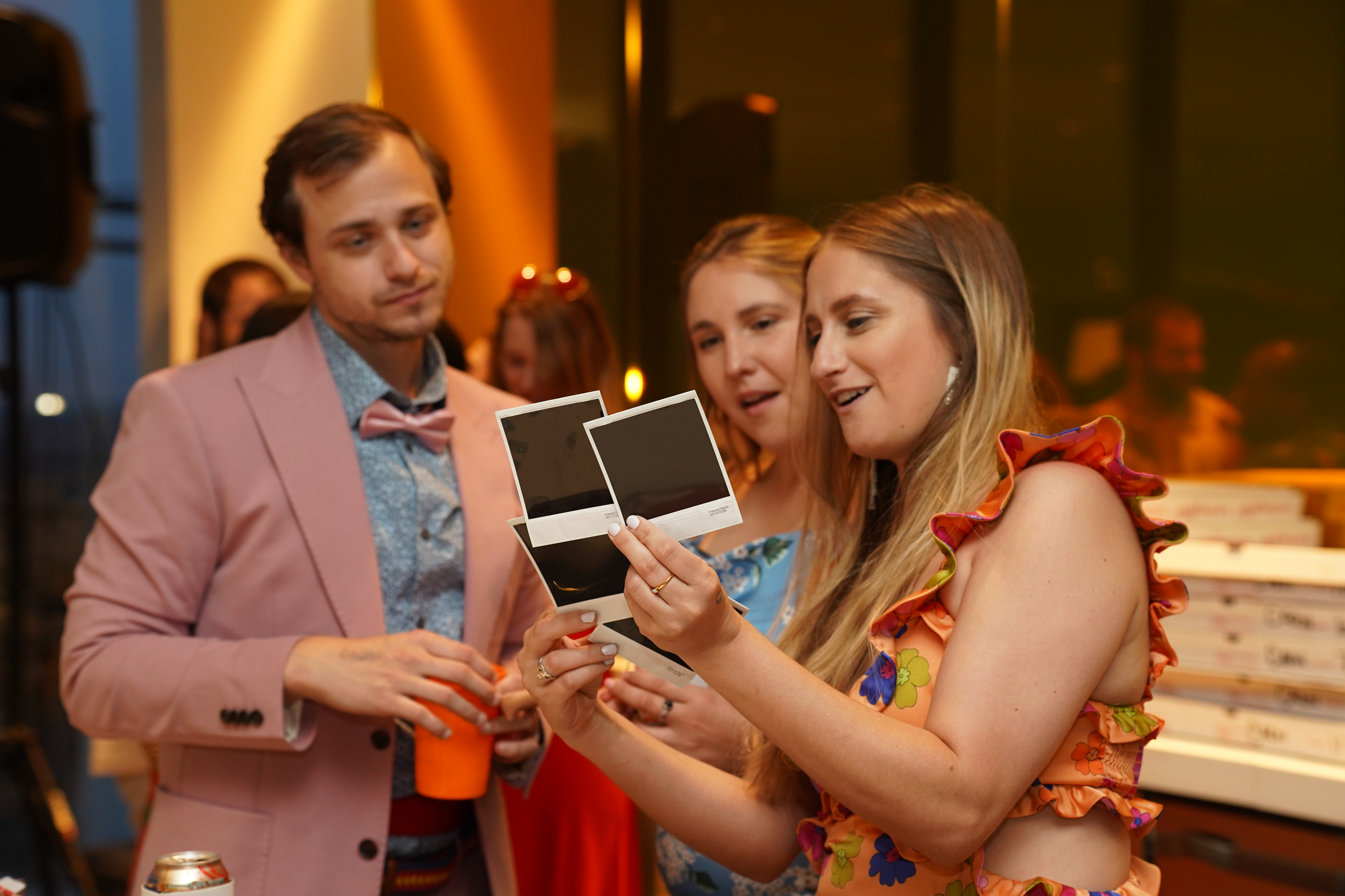 Friends looking at Polaroid photos