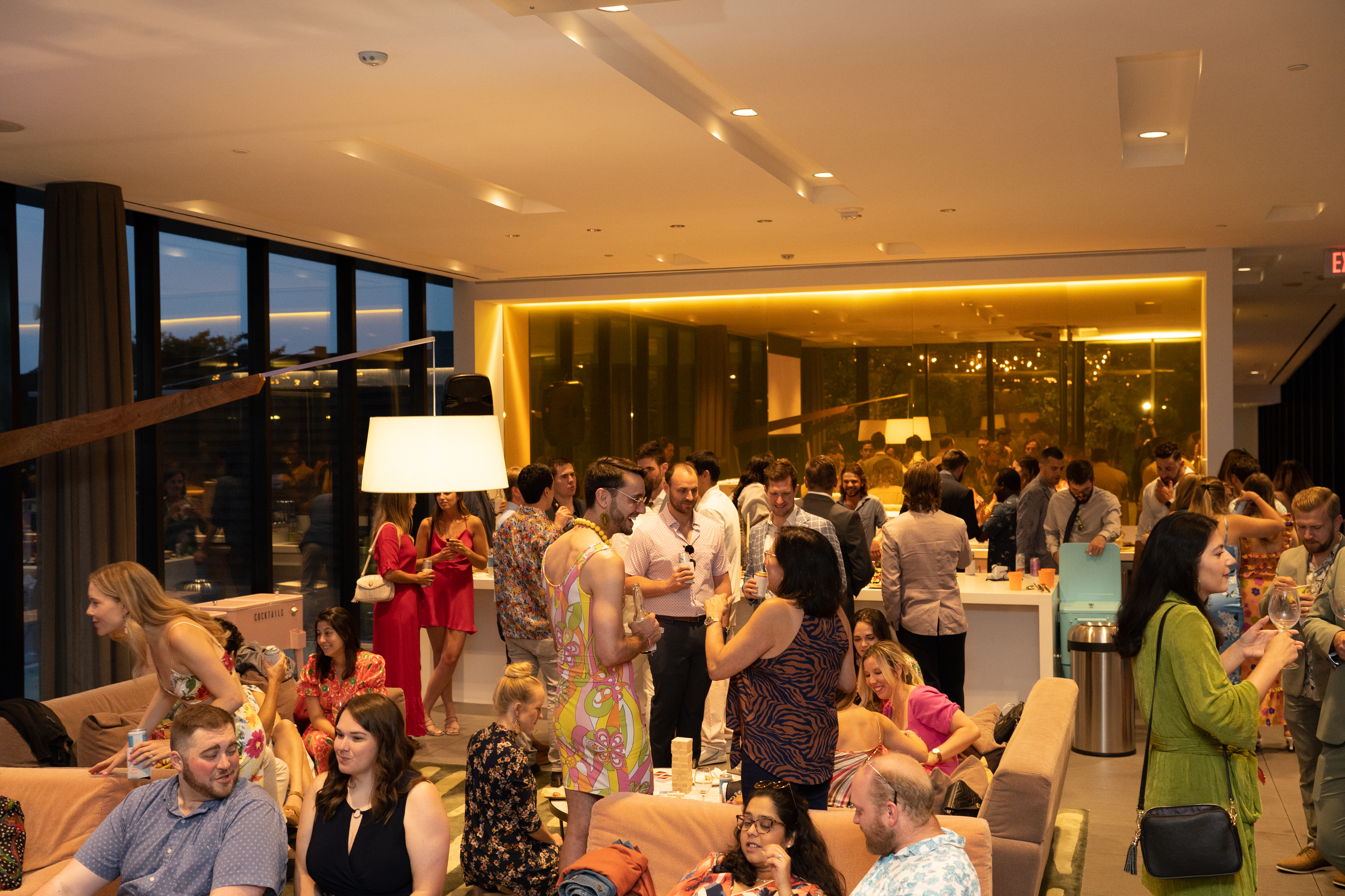 Packed rooftop lounge with guests mingling
