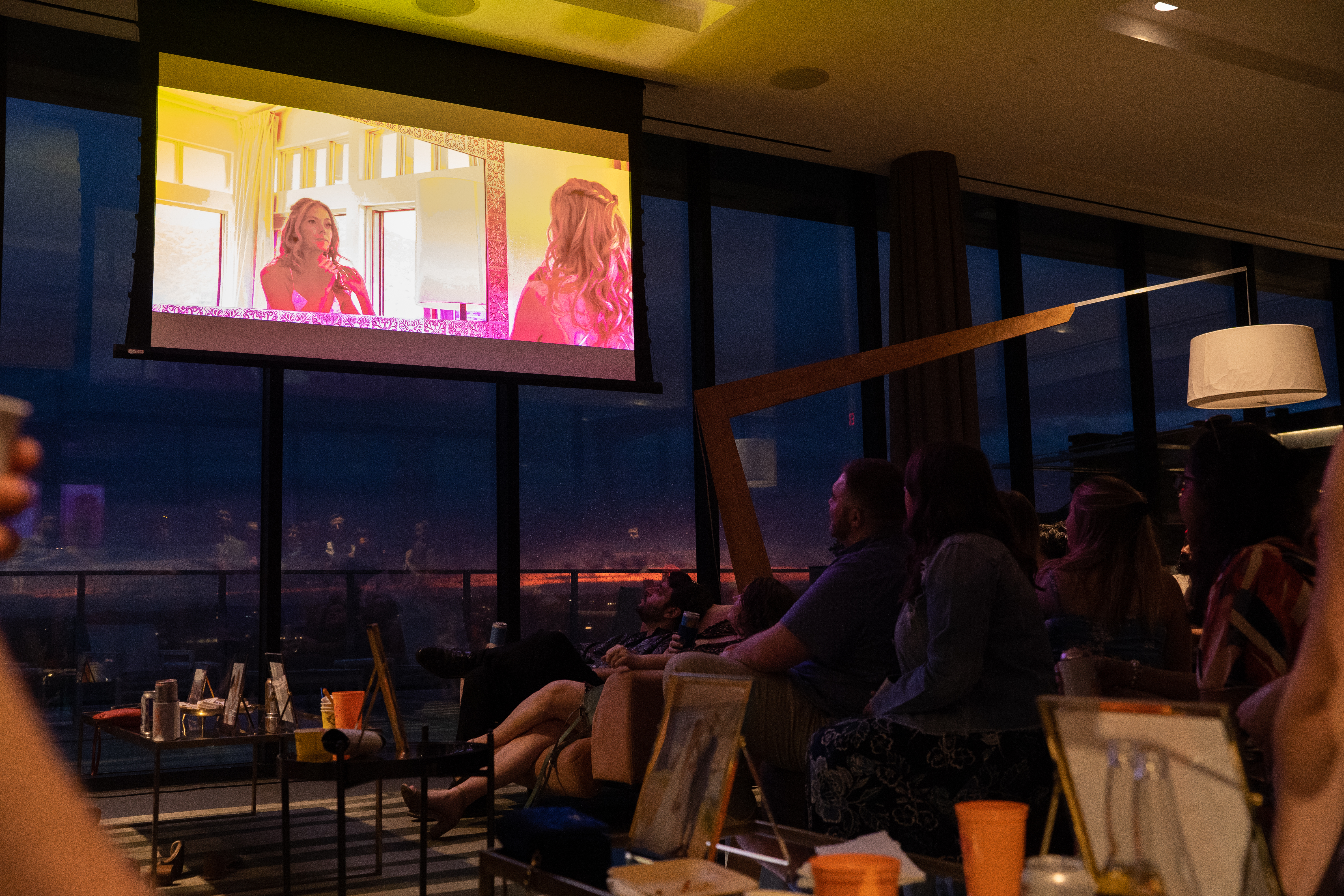 Wedding video playing on projector screen at sunset